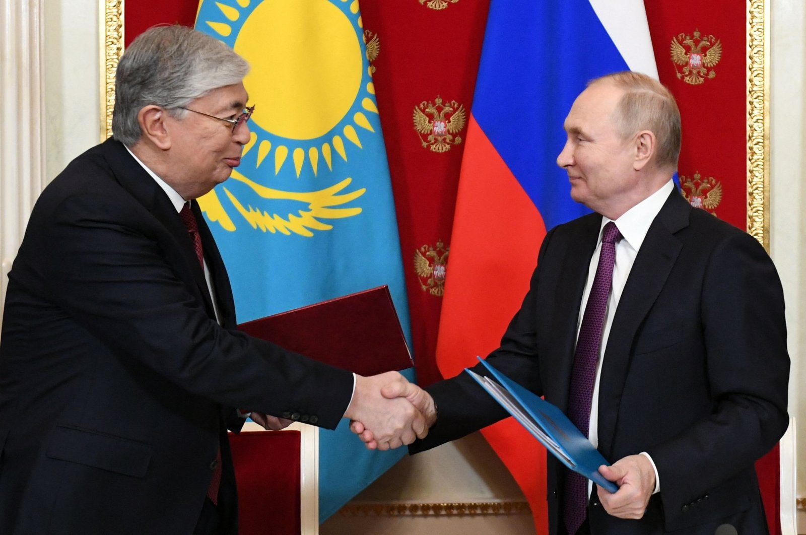 Russian President Vladimir Putin (R) shakes hands with his Kazakh counterpart Kassym-Jomart Tokayev (L) after a signing ceremony in the Kremlin in Moscow, Russia, Nov. 28, 2022. (AFP Photo)