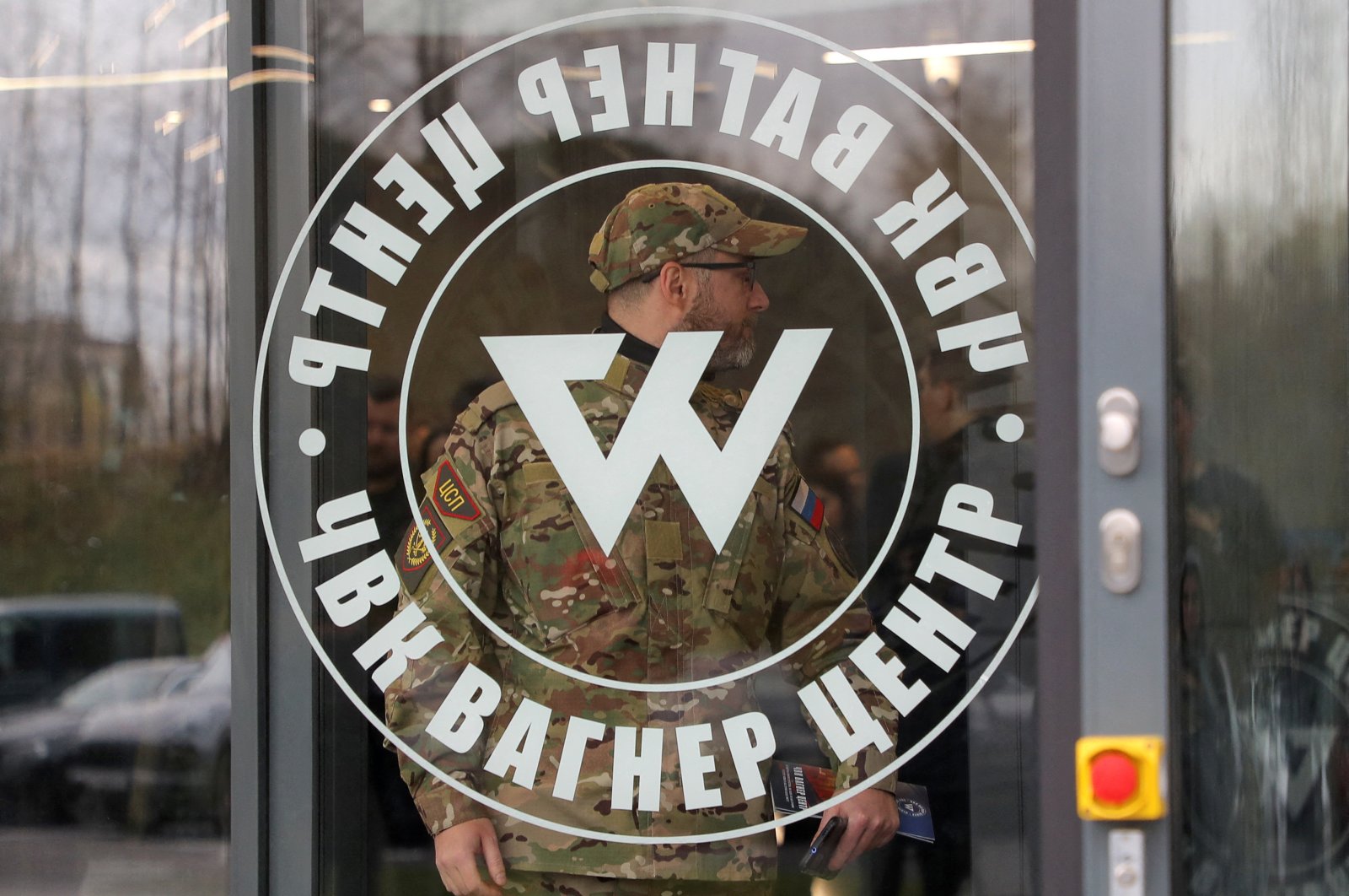 A man wearing a camouflage uniform walks out of PMC Wagner Centre, which is a project implemented by the businessman and founder of the Wagner private military group Yevgeny Prigozhin, during the official opening of the office block in Saint Petersburg, Russia, Nov. 4, 2022. (Reuters File Photo)