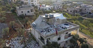 People inspect a destroyed house following an operation by the U.S. military in the Syrian village of Atmeh, in Idlib province, Syria, Feb. 3, 2022. (AP File Photo)
