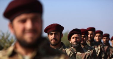 Members of the 1st Corps of the Samarkand Brigade of the Syrian National Army take part in a military parade in the opposition-held Afrin region of northern Syria, Nov. 23, 2022. (AFP Photo)