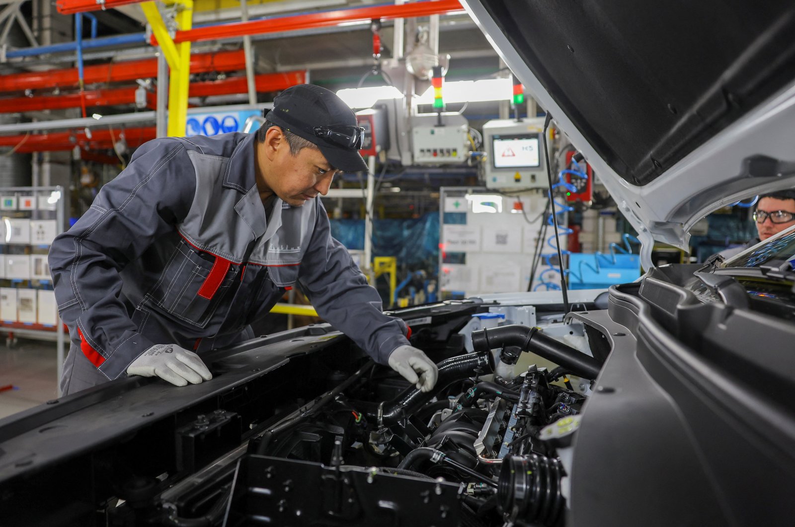 Employees work at the assembly line of the Moscow Automobile Factory Moskvich, after the production of cars under the Soviet-era brand Moskvich at French carmaker Renault's former plant was launched in Moscow, Russia, Nov., 23, 2022. (Reuters Photo)