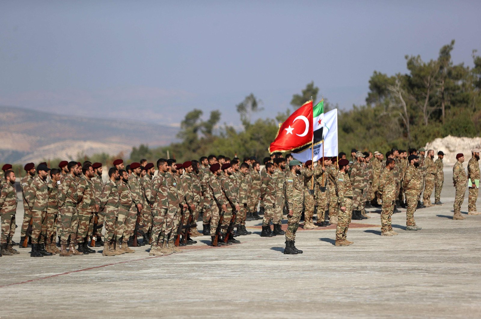 Syrian fighters from the 1st Corps of the Samarkand Brigade take part in a military parade in the opposition-held Afrin region of northern Syria, Nov. 23, 2022. (AFP Photo)