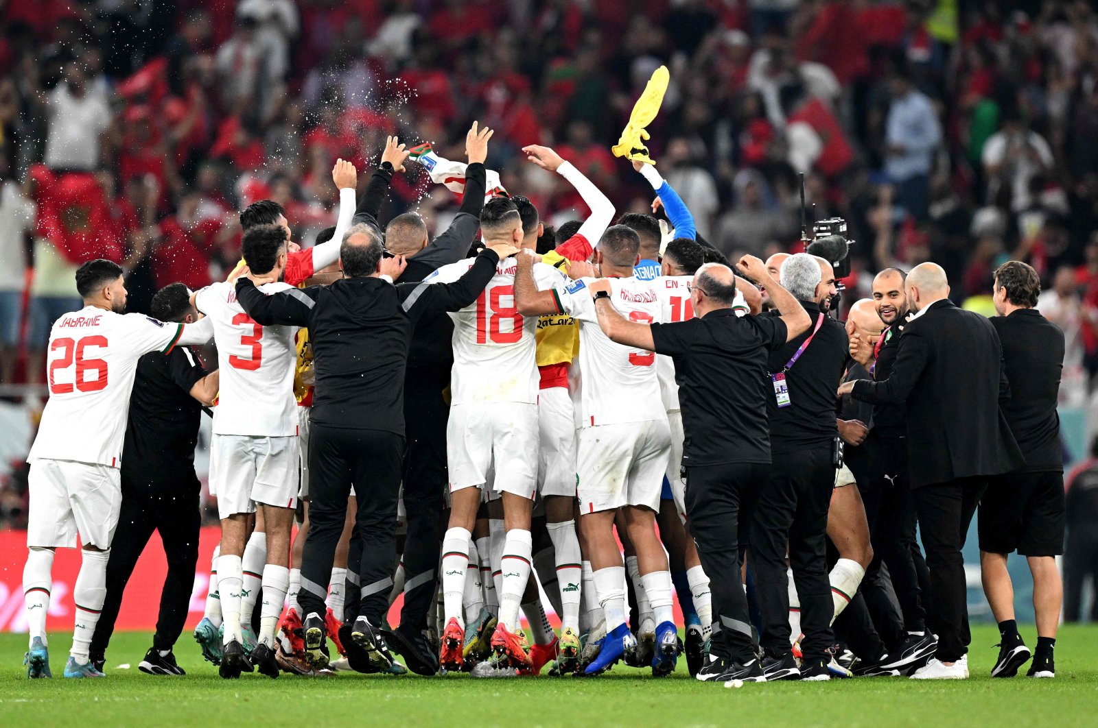 Morocco players and staff members celebrate after they won the Qatar 2022 World Cup Group F football match between Canada and Morocco at the Al-Thumama Stadium to advance to the round of 16, in Doha, Qatar, Dec. 1, 2022. (AFP Photo)