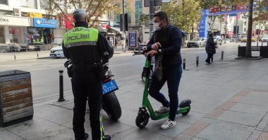 A traffic police officer inspects a scooter rider, Istanbul, Türkiye, Nov. 1, 2021. (AA Photo)