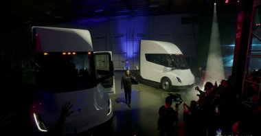 Tesla Chief Executive Elon Musk waves near Tesla Semi electric trucks during a live-streamed unveiling in Nevada, U.S. Dec. 1, 2022, in this still image taken from video. (Tesla Handout via REUTERS)