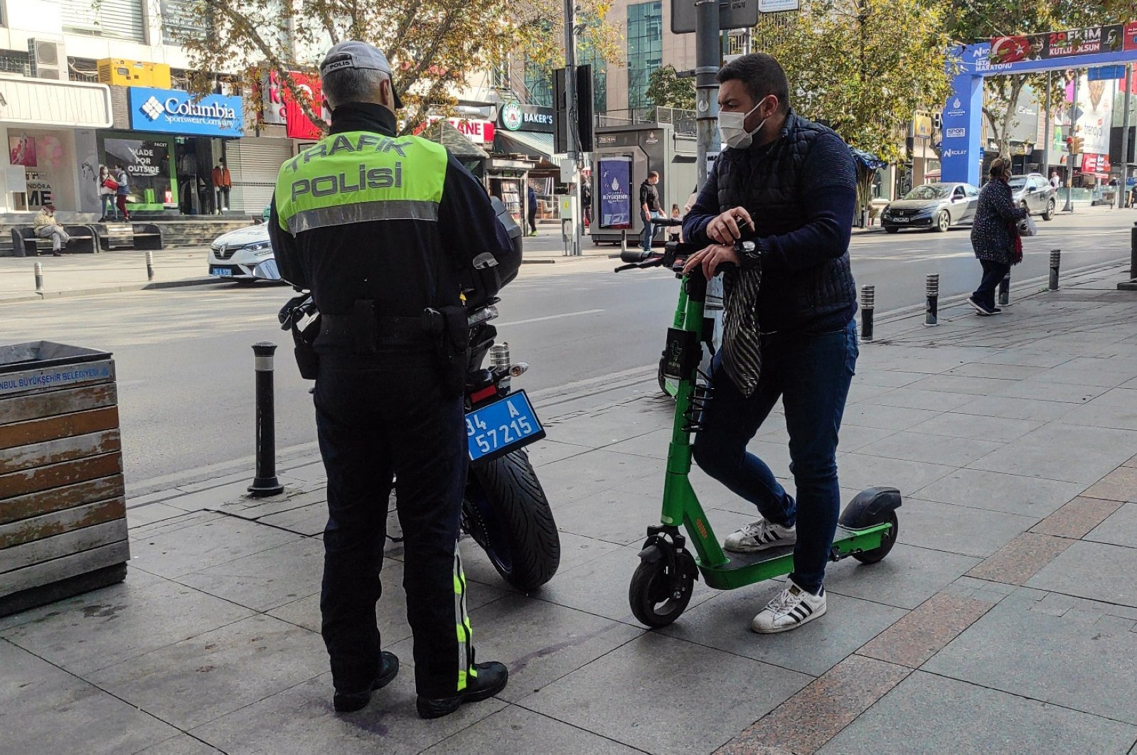 A traffic police officer inspects a scooter rider, Istanbul, Türkiye, Nov. 1, 2021. (AA Photo)