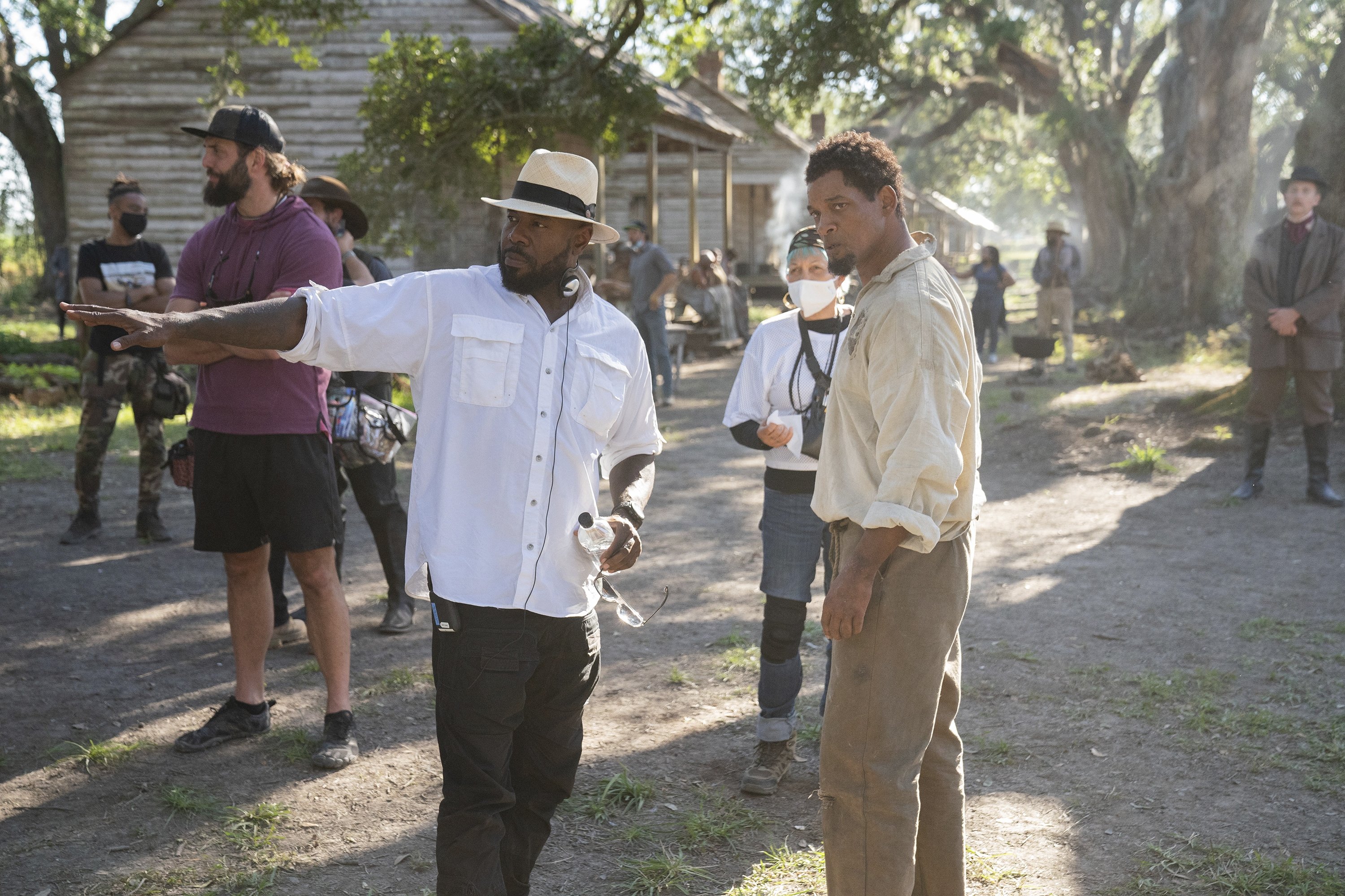 This image released by Apple TV  shows director Antoine Fuqua (L) and actor Will Smith on the set of 