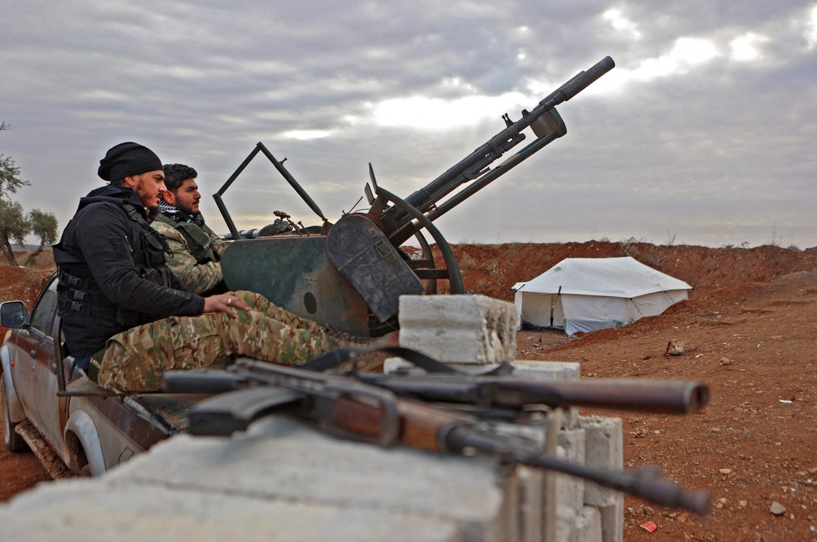 Fighters affiliated with the third corps of the Turkish-backed Syrian National Army (SNA) man a turret at a position near Azaz in the opposition-held north of the Aleppo province, Syria, Nov. 29, 2022. (AFP Photo)