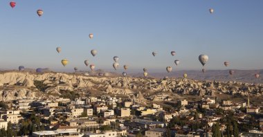 Hot air balloons float over the city of Göreme in Cappadocia, Türkiye, Oct. 21, 2022. (Reuters Photo)