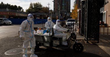 Pandemic prevention workers in protective suits enter an apartment compound that was placed under lockdown as outbreaks of COVID-19 continue in Beijing, China, Nov. 12, 2022. (Reuters Photo)