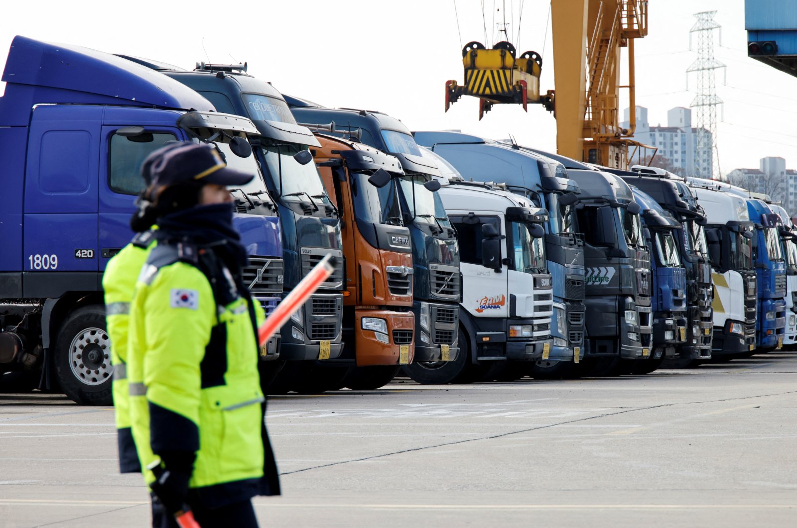 Police officers walk past a parked truck at a terminal of the Inland Container Depot in Uiwang, South Korea, Nov., 30, 2022. (Reuters Photo)