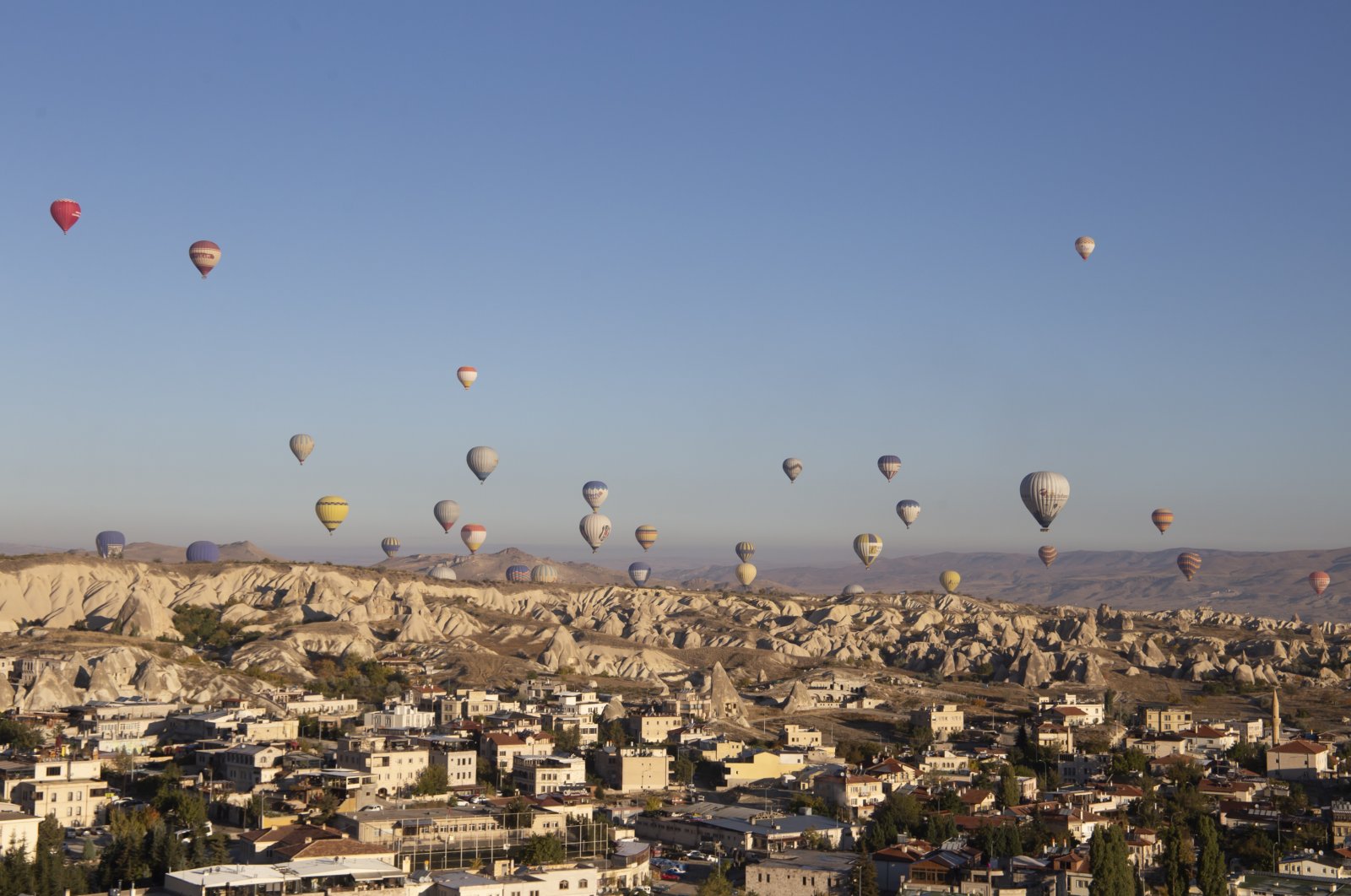 Hot air balloons float over the city of Göreme in Cappadocia, Türkiye, Oct. 21, 2022. (Reuters Photo)