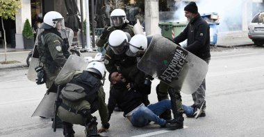 Riot police officers detain a protester following clashes between members of the Roma community in Thessaloniki, Greece, Dec. 5, 2022. (AFP Photo)