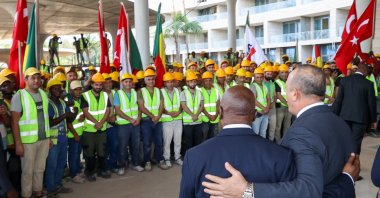 Benin&#039;s Foreign Minister Aurelien Agbenonci (L) and Foreign Minister Mevlüt Çavuşoğlu (R) visit construction workers in Kotonu, Benin, Oct. 27, 2022. (AA Photo)