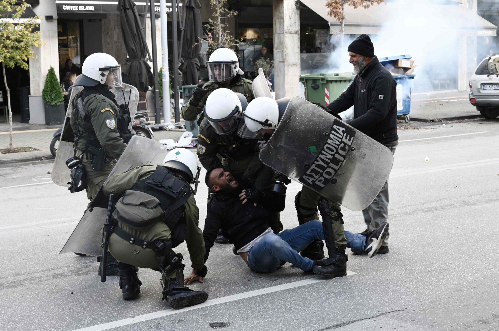 Riot police officers detain a protester following clashes between members of the Roma community in Thessaloniki, Greece, Dec. 5, 2022. (AFP Photo)