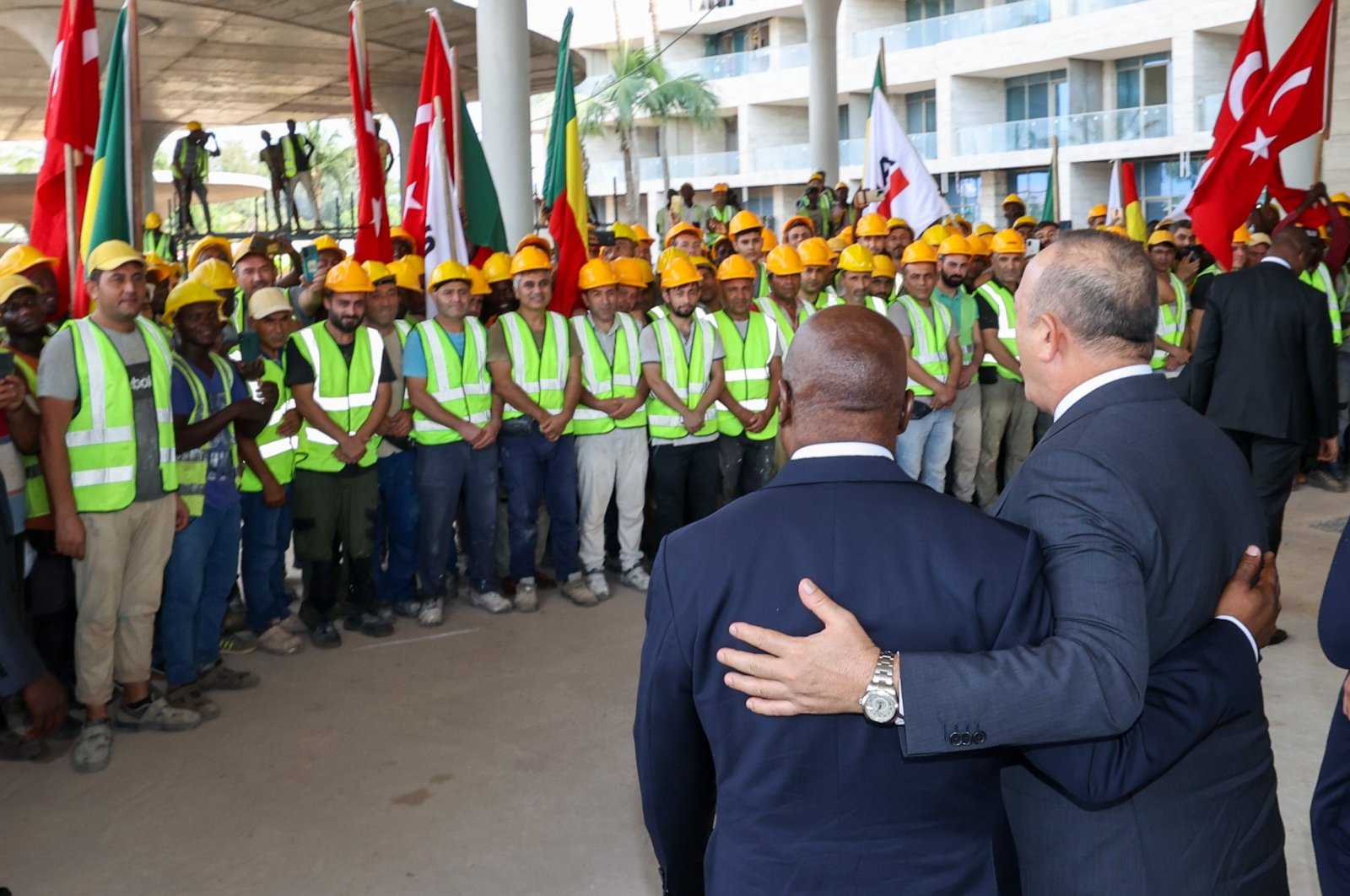 Benin&#039;s Foreign Minister Aurelien Agbenonci (L) and Foreign Minister Mevlüt Çavuşoğlu (R) visit construction workers in Kotonu, Benin, Oct. 27, 2022. (AA Photo)