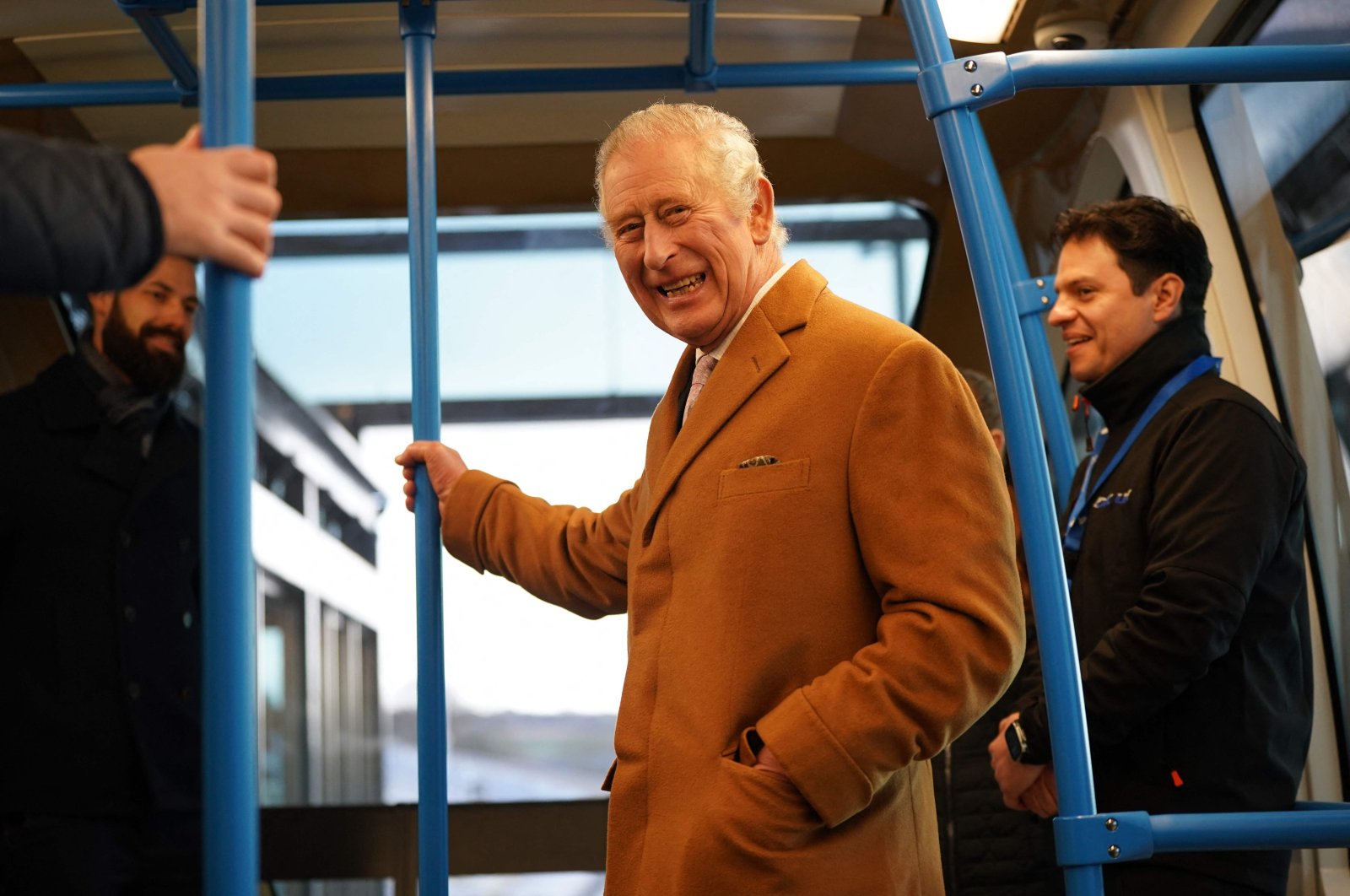Britain&#039;s King Charles III travels in a DART carriage, to the Luton DART central terminal, during a visit to Luton DART Parkway Station in Luton, north of London where he learned about the new cable-drawn mass passenger transit system which will connect Luton Airport Parkway rail station to London Luton Airport, Dec 6. (AFP Photo)