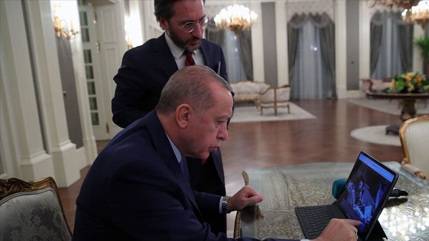 President Recep Tayyip Erdoğan checks photos on a tablet computer, in the capital Ankara, Türkiye, Dec. 30, 2019. (AA Photo)