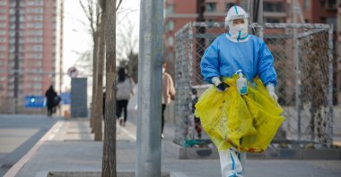 A volunteer health worker walks on the street in Beijing, China, Dec. 7, 2022. (EPA Photo)