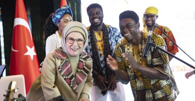 First lady Emine Erdoğan, tries a rhythm on the request of African students at the Africa House program held at the Presidential Complex, Ankara, Türkiye, Dec. 6, 2022. (AA Photo)