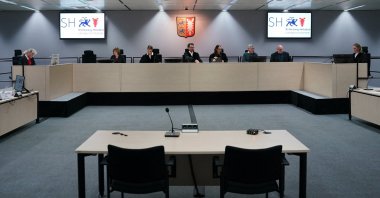 Public prosecutor Maxi Wantzen (R) and presiding judge Dominik Gross (C) are pictured before the continuation of a trial against defendant Irmgard F., a former secretary for the SS commander of the Stutthof concentration camp, at court in Itzehoe, northern Germany, Nov. 22, 2022. (AFP File Photo)