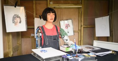 Robot artist Ai-da paints portraits during day two of the Glastonbury Festival at Worthy Farm, Pilton in Glastonbury, U.K., June 23, 2022. (Getty Images Photo)