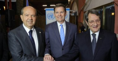 Special representative of the U.N. secretary-general and head of the UNFICYP, Colin Stewart (C), shakes hands with Greek Cypriot President Nicos Anastasiades (R) and Turkish Cypriot leader Ersin Tatar (L) during a reception at Ledra Palace in Lefkoşa (Nicosia), TRNC, Dec. 7, 2022. (Reuters Photo)