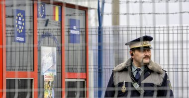 A Romanian border police officer stands guard at the railway border crossing point between Romania and Moldova in Ungheni, Romania, Jan. 18, 2011. (AP Photo)