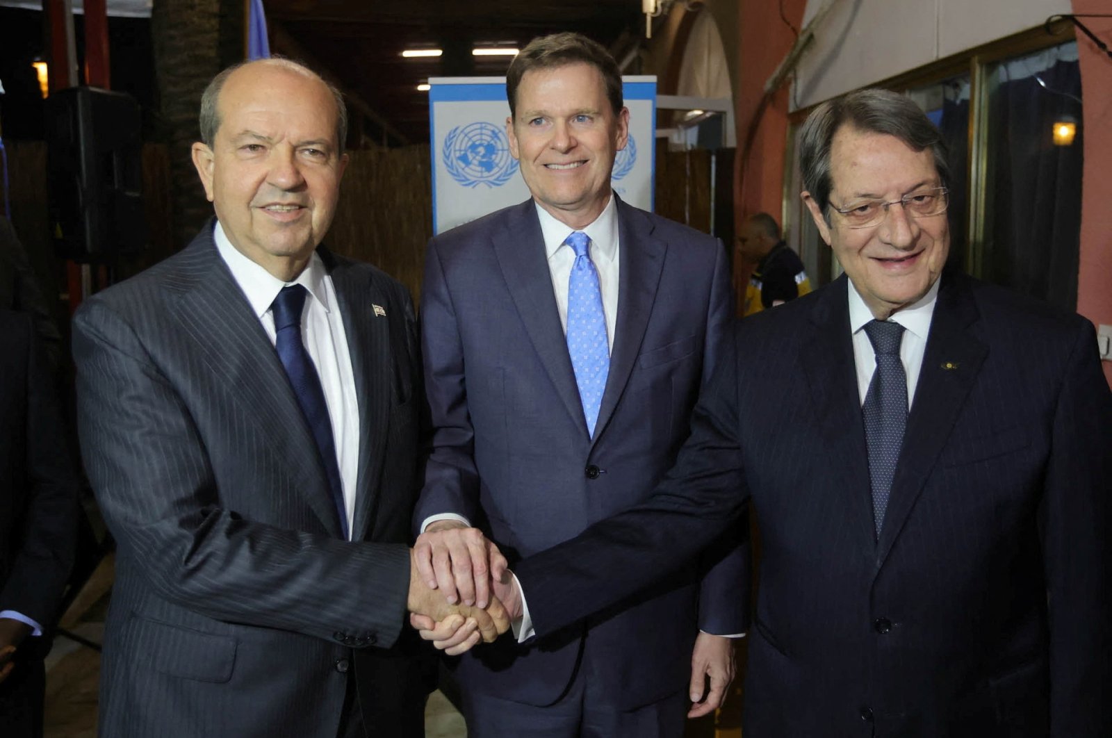 Special representative of the U.N. secretary-general and head of the UNFICYP, Colin Stewart (C), shakes hands with Greek Cypriot President Nicos Anastasiades (R) and Turkish Cypriot leader Ersin Tatar (L) during a reception at Ledra Palace in Lefkoşa (Nicosia), TRNC, Dec. 7, 2022. (Reuters Photo)