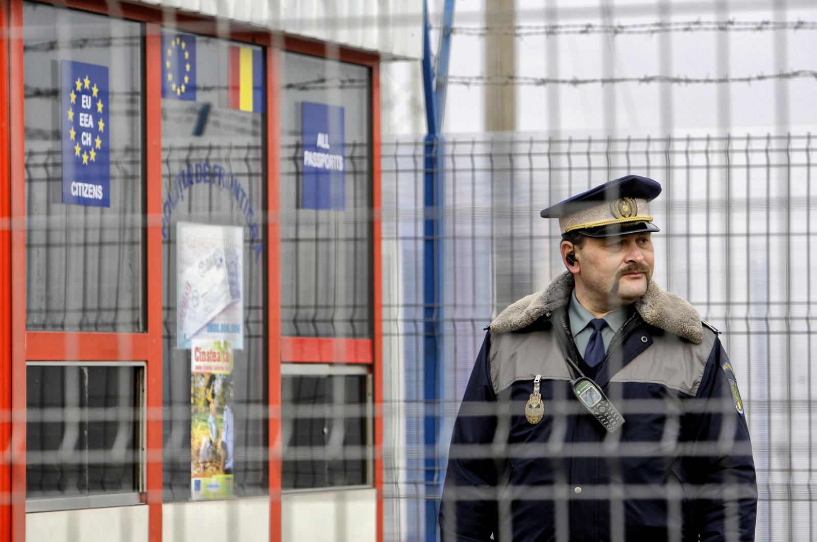 A Romanian border police officer stands guard at the railway border crossing point between Romania and Moldova in Ungheni, Romania, Jan. 18, 2011. (AP Photo)