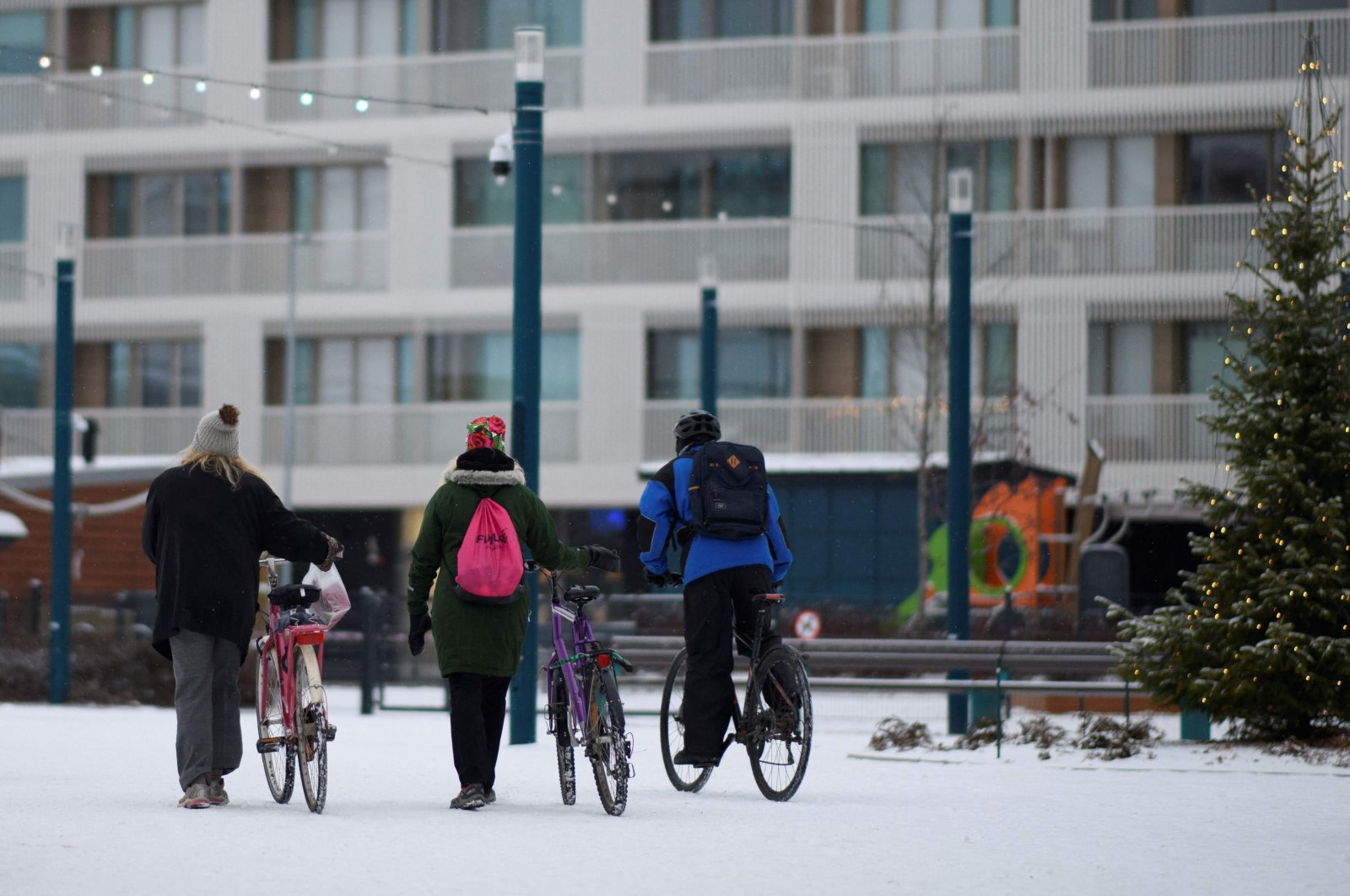 People with bicycles, in Oulu, Finland, Dec. 1, 2022. (AFP Photo)