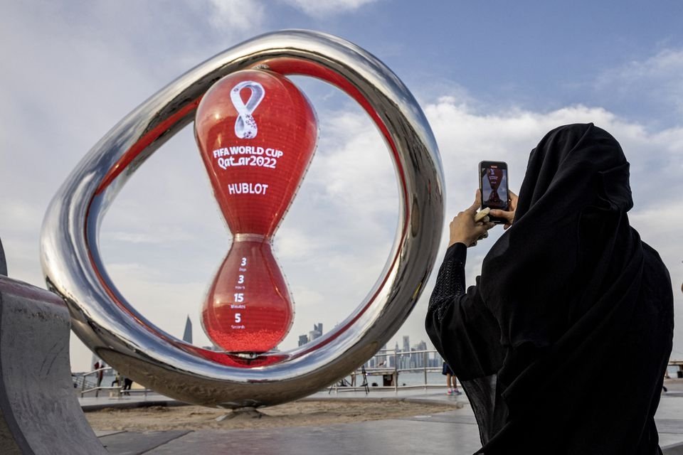 A fan takes a photograph of a countdown clock to the start of the FIFA World Cup, in Doha, Qatar, Nov. 17, 2022. (Reuters Photo) 