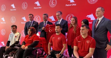 Turkish Physically Handicapped Sports Federation President Muaz Ergezen, Petrol Office Chief Executive Officer (CEO) Mehmet Abbasoğlu and national para-athletes pose for picture at a hotel in Taksim, Istanbul, Türkiye. (AA Photo)