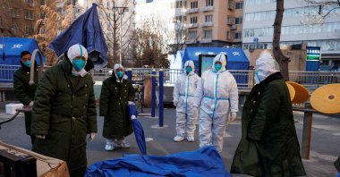 Pandemic control workers take down tents in Beijing, China, Dec. 10, 2022. (Reuters Photo)