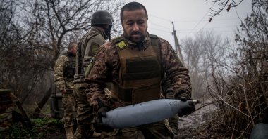 A Ukrainian artilleryman carries a shell near Donetsk, Ukraine, Dec. 10, 2022. (AFP Photo)