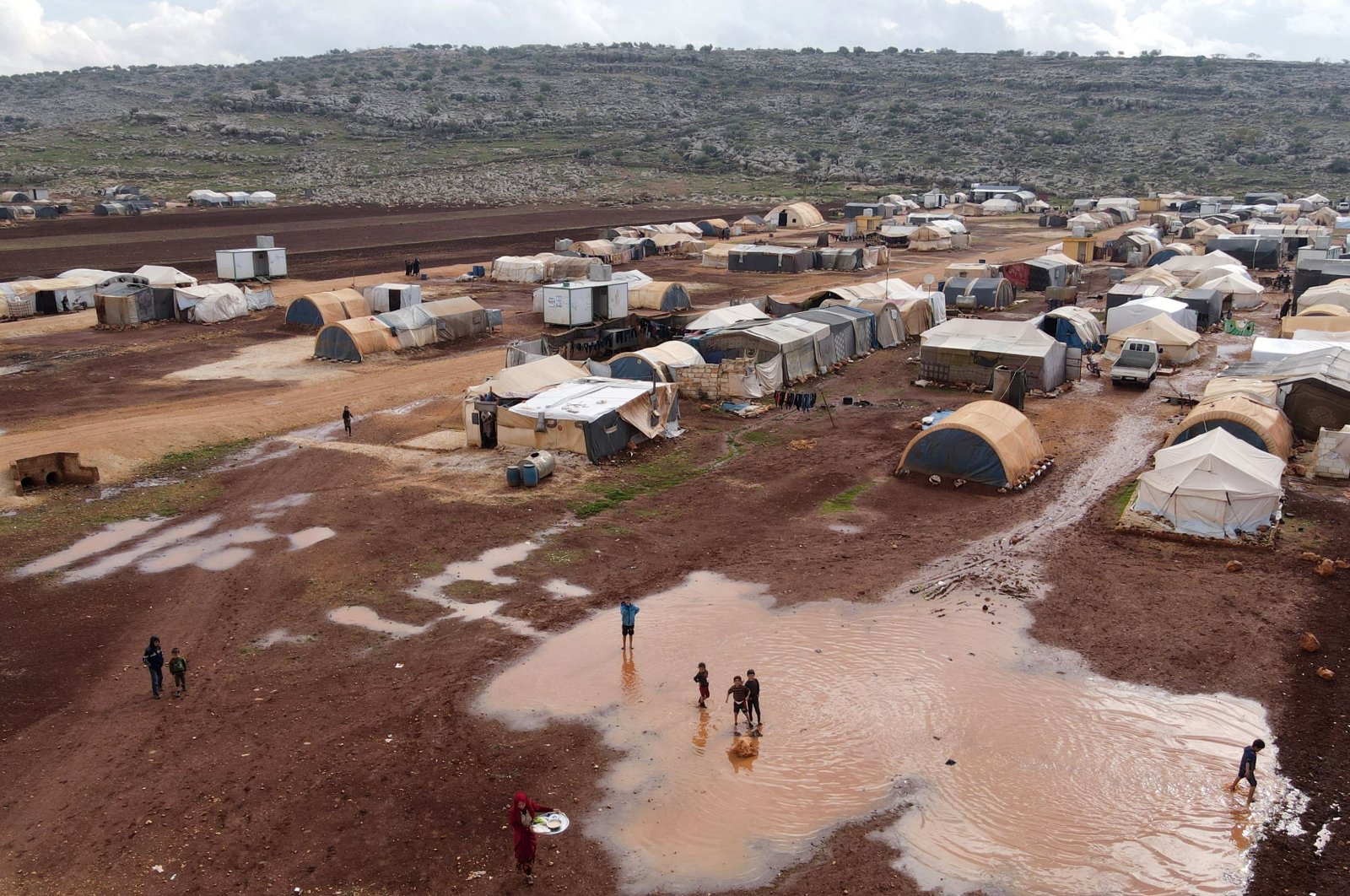This aerial view shows large puddles after heavy rain, at the Kafr Arouk camp for internally displaced people in the opposition-held northern countryside of Syria&#039;s Idlib province, Nov. 25, 2022. (AFP Photo)
