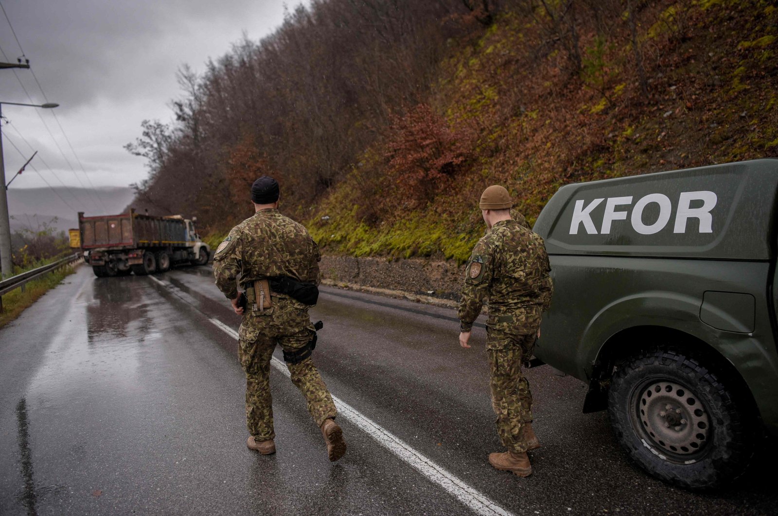 NATO peacekeepers in Kosovo (KFOR) inspect a road barricade set up by ethnic Serbs near the town of Zubin Potok, Kosovo, Dec. 11, 2022. (AFP Photo)