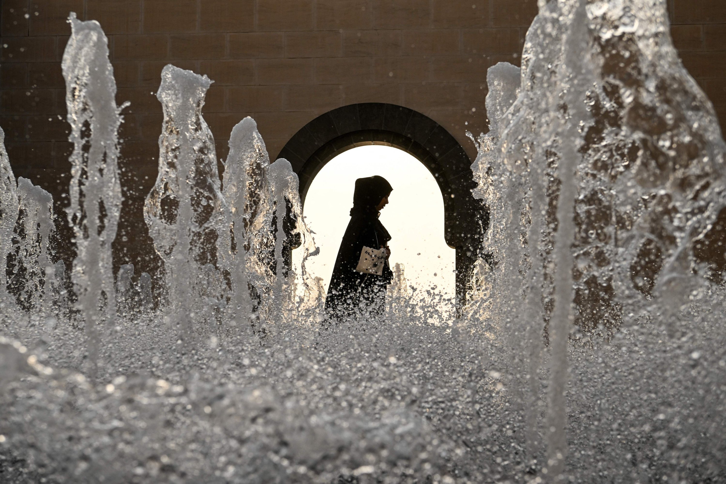 A woman walks past the fountains on the balcony at the Museum of Islamic Art in Doha, ahead of the Qatar 2022 World Cup football tournament, Qatar, Nov.13, 2022. (AFP Photo)