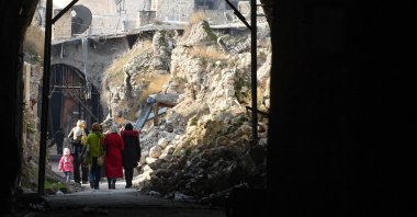 People walk toward a covered market in the regime-controlled northern city of Aleppo, Syria, Dec. 10, 2022. (AFP Photo)