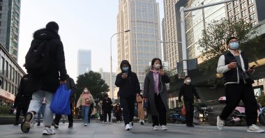 People walk on a street during morning rush hour in Wuchang district, after the government gradually loosened the restrictions on COVID-19 control, Wuhan, Hubei province, China, Dec. 9, 2022. (Reuters Photo)