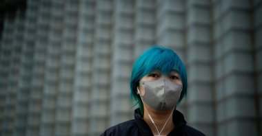 A woman wearing a face mask walks on the street, as coronavirus disease (COVID-19) outbreaks continue in Shanghai, China, Dec.12, 2022. (Reuters Photo)