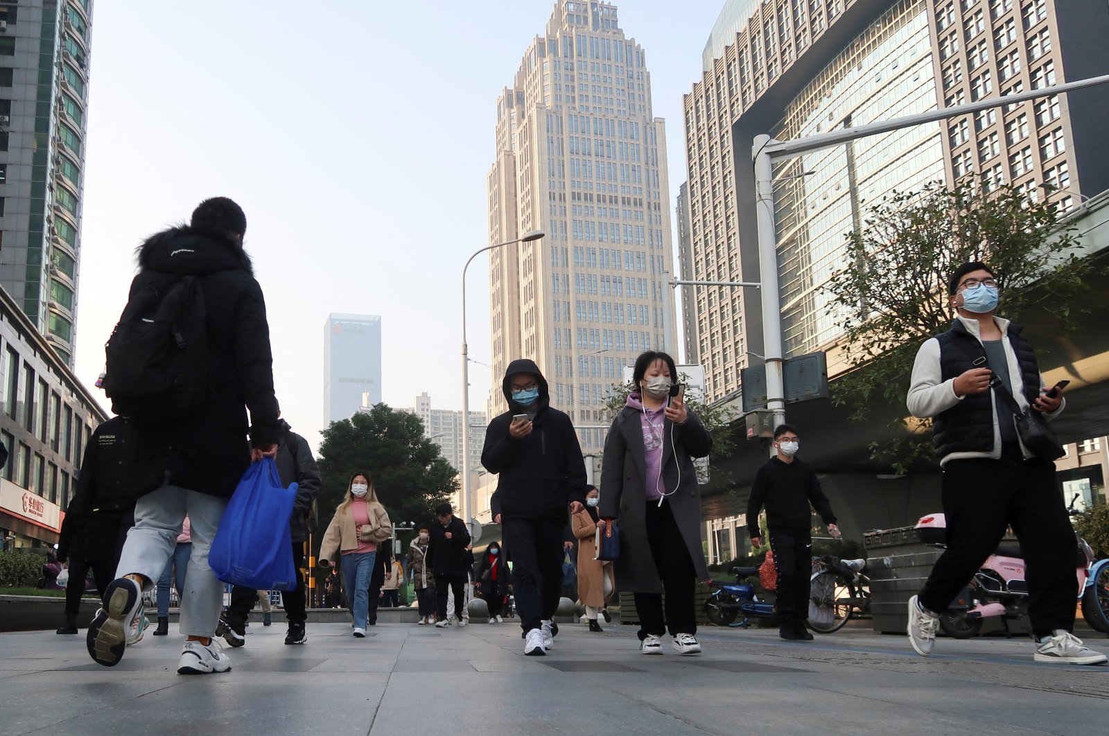People walk on a street during morning rush hour in Wuchang district, after the government gradually loosened the restrictions on COVID-19 control, Wuhan, Hubei province, China, Dec. 9, 2022. (Reuters Photo)