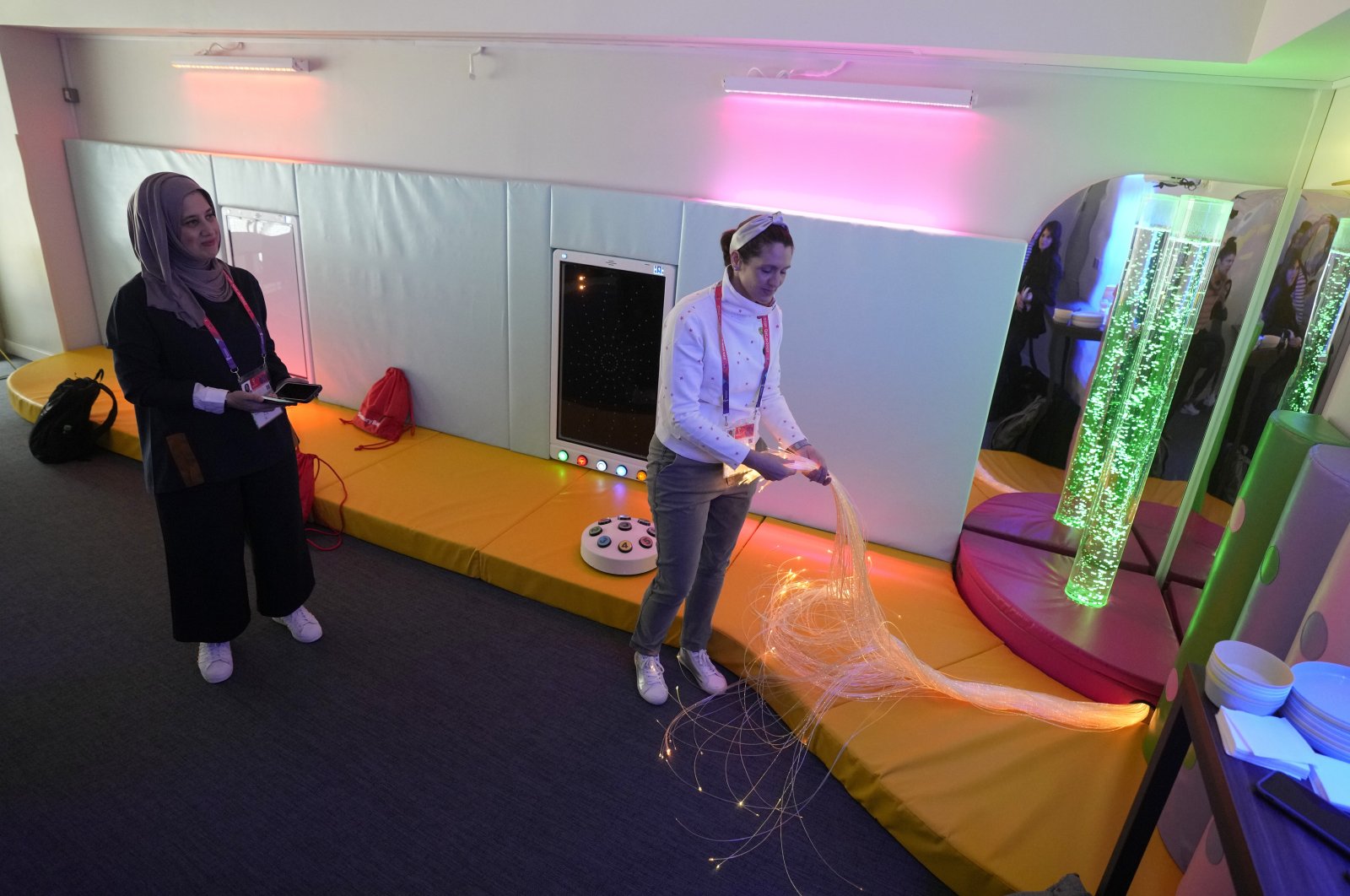 Raana Smith, left and Alison Saraf co-founders of Sensory Souk, carry out a demonstration of a sensory room at the Lusail Stadium in Lusail, Qatar, Saturday, Dec. 10, 2022. (AP Photo)