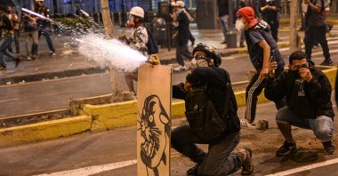 Supporters of former President Pedro Castillo launch firecrackers at riot police during a protest in Lima, Peru, Dec. 12, 2022. (AFP Photo)