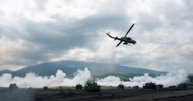 Japan Ground Self-Defense Force (JGSDF) battle tanks and a helicopter take part in the annual live-fire exercise at East Fuji Maneuver Area, in Gotemba, Shizuoka, Japan, May 28, 2022. (Reuters Photo)