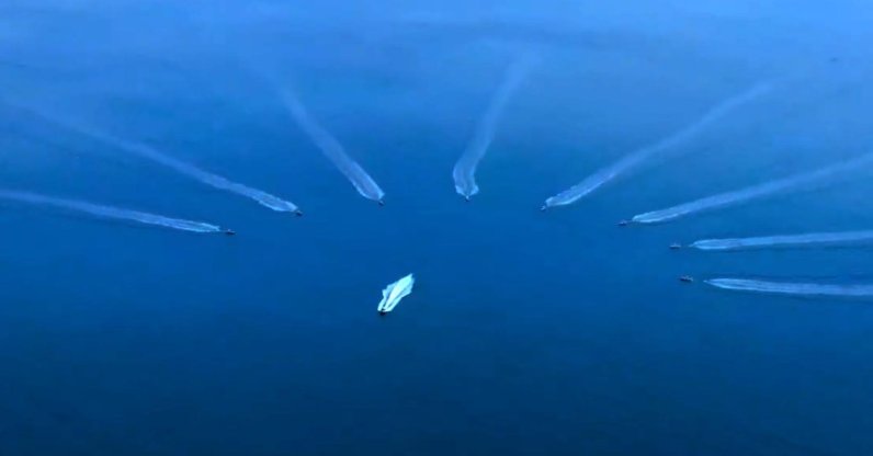 A screen-grab from the video Ismail Demir, the head of the Presidency of Defense Industries (SSB), shared showing the moment when the 8-herd swarm of indigenous armed unmanned surface vessels push away a suspicious boat, Ankara, Türkiye, Dec. 13, 2022. (DHA Photo)