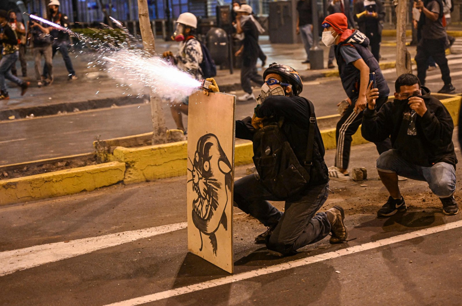 Supporters of former President Pedro Castillo launch firecrackers at riot police during a protest in Lima, Peru, Dec. 12, 2022. (AFP Photo)