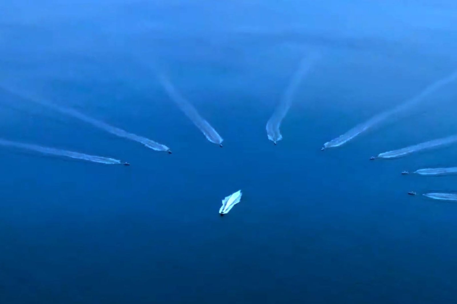 A screen-grab from the video Ismail Demir, the head of the Presidency of Defense Industries (SSB), shared showing the moment when the 8-herd swarm of indigenous armed unmanned surface vessels push away a suspicious boat, Ankara, Türkiye, Dec. 13, 2022. (DHA Photo)