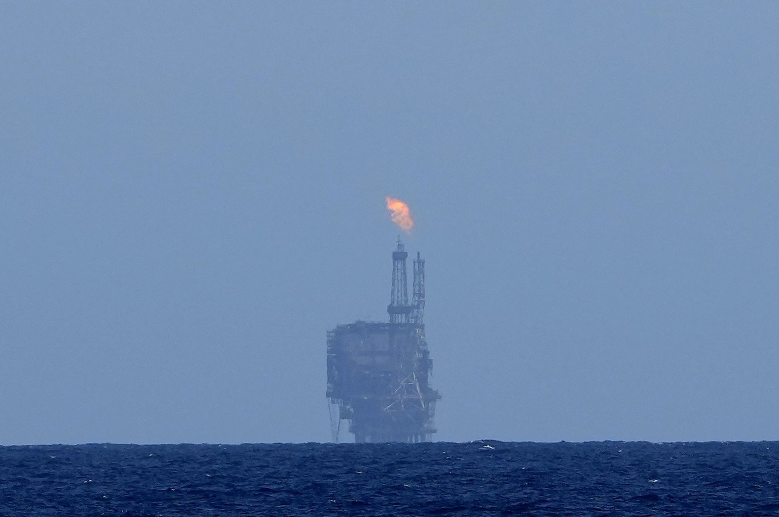 An oil platform is visible on the horizon in the international waters zone near Libya in the Mediterranean Sea, Sept. 17, 2022. (AP Photo)
