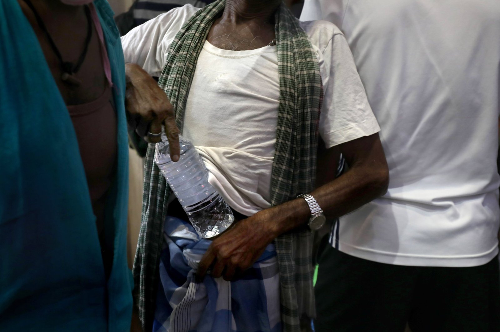 A customer carries a bottle after buying alcohol at a liquor store in Kolkata, eastern India, May 15, 2021. (EPA Photo)